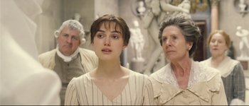 Movie still from “Pride & Prejudice” (2005), directed by Joe Wright – A young woman standing next to two older women; Close Up shot, Over the shoulder angle