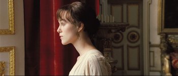 Movie still from “Pride & Prejudice” (2005), directed by Joe Wright – A woman with a bun and a white shirt looking to the side; Close Up shot, Low angle