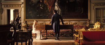 Movie still from “Pride & Prejudice” (2005), directed by Joe Wright – A man and a woman playing piano in front of a painting; Wide shot, High angle