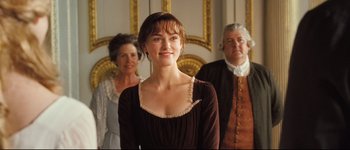 Movie still from “Pride & Prejudice” (2005), directed by Joe Wright – A woman standing in front of two other people; Medium shot, Over the shoulder angle