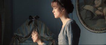 Movie still from “Pride & Prejudice” (2005), directed by Joe Wright – A woman standing in front of a mirror with her eyes closed; Close Up shot, Over the shoulder angle