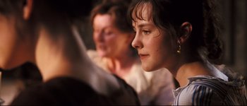 Movie still from “Pride & Prejudice” (2005), directed by Joe Wright – A woman looking at the camera while another woman looks on; Close Up shot, High angle