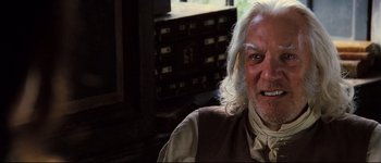 Movie still from “Pride & Prejudice” (2005), directed by Joe Wright – An older man with long white hair sitting in a room; Close Up shot, Low angle