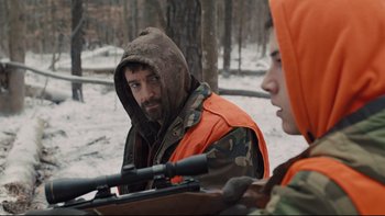Movie still from “Prisoners” (2013), directed by Denis Villeneuve – A man with a rifle and a boy with a rifle; Medium shot, Over the shoulder angle