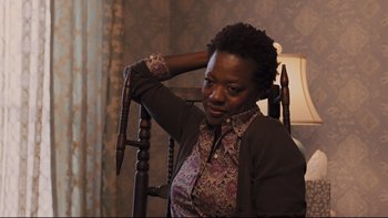 Movie still from “Prisoners” (2013), directed by Denis Villeneuve – A woman sitting in a chair in front of a lamp; Close Up shot, High angle