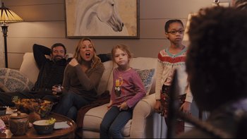 Movie still from “Prisoners” (2013), directed by Denis Villeneuve – A group of people sitting in a living room; Medium shot, Over the shoulder angle