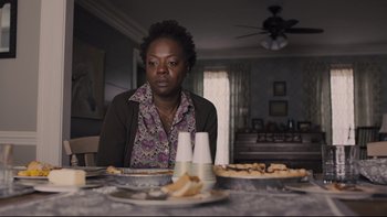 Movie still from “Prisoners” (2013), directed by Denis Villeneuve – A woman sitting at a table with a plate of food on it; Close Up shot, Over the shoulder angle