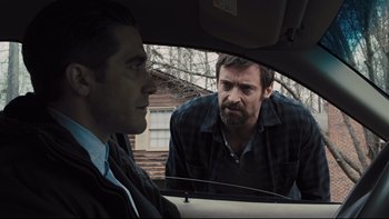 Movie still from “Prisoners” (2013), directed by Denis Villeneuve – Two men are looking at each other in the back of a car; Close Up shot, Over the shoulder angle