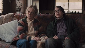 Movie still from “Prisoners” (2013), directed by Denis Villeneuve – Two people sitting on a couch with a dog; Medium shot, Low angle
