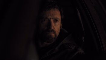 Movie still from “Prisoners” (2013), directed by Denis Villeneuve – A person with a beard looking at the camera; Close Up shot, Over the shoulder angle