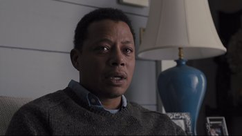 Movie still from “Prisoners” (2013), directed by Denis Villeneuve – A person sitting in a room near a lamp; Close Up shot, High angle