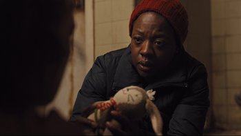 Movie still from “Prisoners” (2013), directed by Denis Villeneuve – A person holding a stuffed animal in a room; Close Up shot, Over the shoulder angle