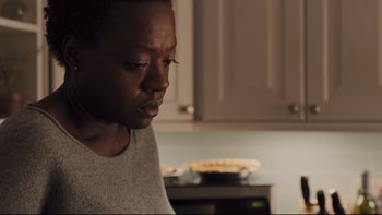 Movie still from “Prisoners” (2013), directed by Denis Villeneuve – A person in a kitchen looking down at a pie; Close Up shot, Over the shoulder angle