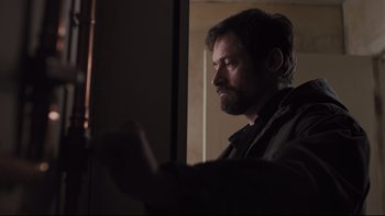 Movie still from “Prisoners” (2013), directed by Denis Villeneuve – A man looking at something in the dark; Close Up shot, Low angle