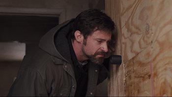 Movie still from “Prisoners” (2013), directed by Denis Villeneuve – A person leaning against a wall; Close Up shot, Low angle