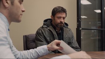 Movie still from “Prisoners” (2013), directed by Denis Villeneuve – A man sitting in front of another man at a table; Medium shot, Over the shoulder angle
