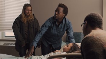 Movie still from “Prisoners” (2013), directed by Denis Villeneuve – A man standing next to a child in a hospital bed; Medium shot, Over the shoulder angle