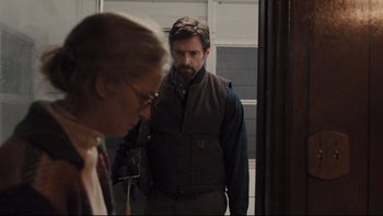 Movie still from “Prisoners” (2013), directed by Denis Villeneuve – A man and a woman standing next to each other in a doorway; Medium shot, Over the shoulder angle