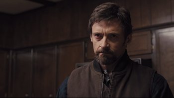 Movie still from “Prisoners” (2013), directed by Denis Villeneuve – A person with a beard wearing a vest; Close Up shot, Over the shoulder angle
