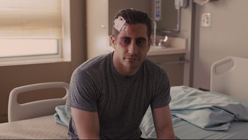 Movie still from “Prisoners” (2013), directed by Denis Villeneuve – A man with a bandage on his head sitting on a hospital bed; Medium shot, Over the shoulder angle