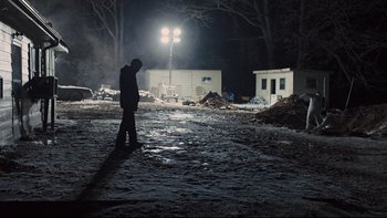Movie still from “Prisoners” (2013), directed by Denis Villeneuve – A man standing in the middle of a field at night; Extreme Wide shot, Low angle