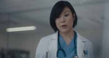 Movie still from “Private Life” (2018), directed by Tamara Jenkins – A woman in a white lab coat with a stethoscope around her neck; Close Up shot, Low angle