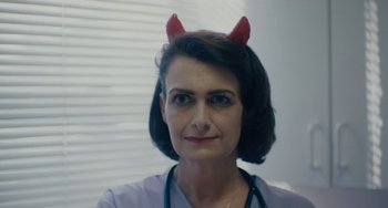 Movie still from “Private Life” (2018), directed by Tamara Jenkins – A woman wearing a devil costume with horns on top of her head; Close Up shot, Low angle