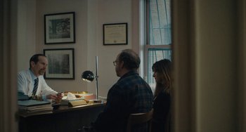 Movie still from “Private Life” (2018), directed by Tamara Jenkins – A man and a woman sitting in front of a lamp; Medium shot, Over the shoulder angle