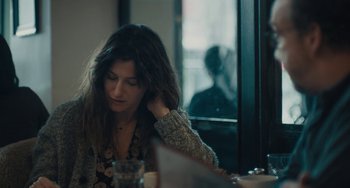 Movie still from “Private Life” (2018), directed by Tamara Jenkins – A woman sitting in front of a window at a table; Close Up shot, Over the shoulder angle