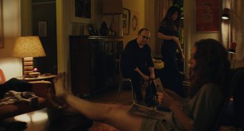 Movie still from “Private Life” (2018), directed by Tamara Jenkins – A man sitting on a chair in front of a woman; Medium shot, High angle