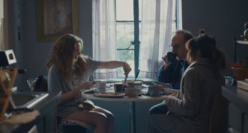 Movie still from “Private Life” (2018), directed by Tamara Jenkins – A group of people sitting at a table drinking coffee; Medium shot, Over the shoulder angle
