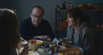 Movie still from “Private Life” (2018), directed by Tamara Jenkins – A man and a woman sitting at a table with a plate of food; Medium shot, Over the shoulder angle