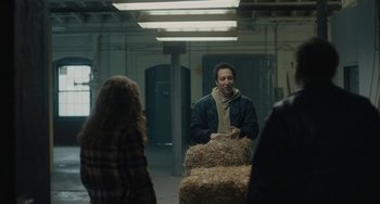 Movie still from “Private Life” (2018), directed by Tamara Jenkins – A man standing next to a group of hay bales; Medium shot, Over the shoulder angle
