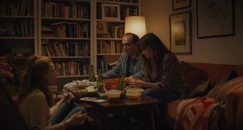 Movie still from “Private Life” (2018), directed by Tamara Jenkins – A group of people sitting around a table eating food; Medium shot, High angle