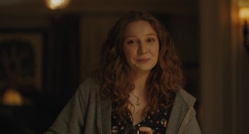 Movie still from “Private Life” (2018), directed by Tamara Jenkins – A person with curly hair holding a cell phone; Close Up shot, Over the shoulder angle
