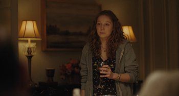 Movie still from “Private Life” (2018), directed by Tamara Jenkins – A young woman holding a wine glass in her hand; Medium shot, Over the shoulder angle