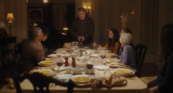 Movie still from “Private Life” (2018), directed by Tamara Jenkins – A group of people sitting around a dinner table; Medium shot, High angle