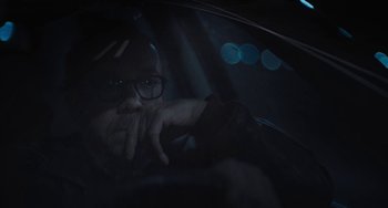 Movie still from “Private Life” (2018), directed by Tamara Jenkins – A man with glasses sitting in a car at night; Close Up shot, Over the shoulder angle