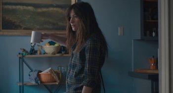 Movie still from “Private Life” (2018), directed by Tamara Jenkins – A woman standing in front of a bowl of food; Medium shot, Over the shoulder angle