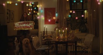 Movie still from “Private Life” (2018), directed by Tamara Jenkins – A woman standing in front of a dining room table; Extreme Wide shot, High angle