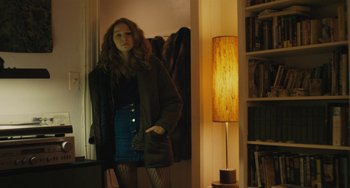 Movie still from “Private Life” (2018), directed by Tamara Jenkins – A woman standing in front of a mirror in a room; Medium shot, Low angle