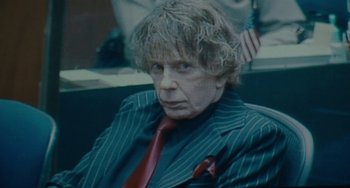 Movie still from “Private Life” (2018), directed by Tamara Jenkins – An older man in a suit and red tie; Close Up shot, Low angle