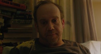 Movie still from “Private Life” (2018), directed by Tamara Jenkins – A person sitting on a couch; Close Up shot, High angle