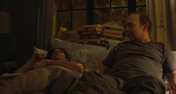 Movie still from “Private Life” (2018), directed by Tamara Jenkins – A man and a woman laying in a bed; Medium shot, High angle