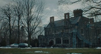 Movie still from “Private Life” (2018), directed by Tamara Jenkins – An old stone building with a car parked in front of it; Extreme Wide shot, Low angle
