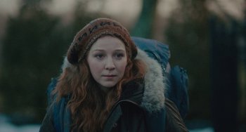 Movie still from “Private Life” (2018), directed by Tamara Jenkins – A woman with long red curly hair wearing a hat; Close Up shot, Over the shoulder angle
