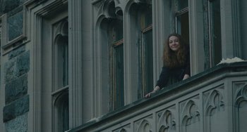Movie still from “Private Life” (2018), directed by Tamara Jenkins – A woman standing on the ledge of an old building; Wide shot, Low angle