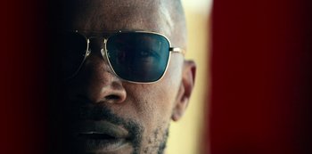 Movie still from “Project Power” (2020), directed by Henry Joost – A person wearing sunglasses; Extreme Close Up shot, Low angle