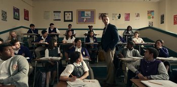 Movie still from “Project Power” (2020), directed by Henry Joost – A man standing in front of a classroom full of students; Medium shot, Over the shoulder angle