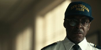 Movie still from “Project Power” (2020), directed by Henry Joost – A person wearing glasses and a cap; Close Up shot, Low angle